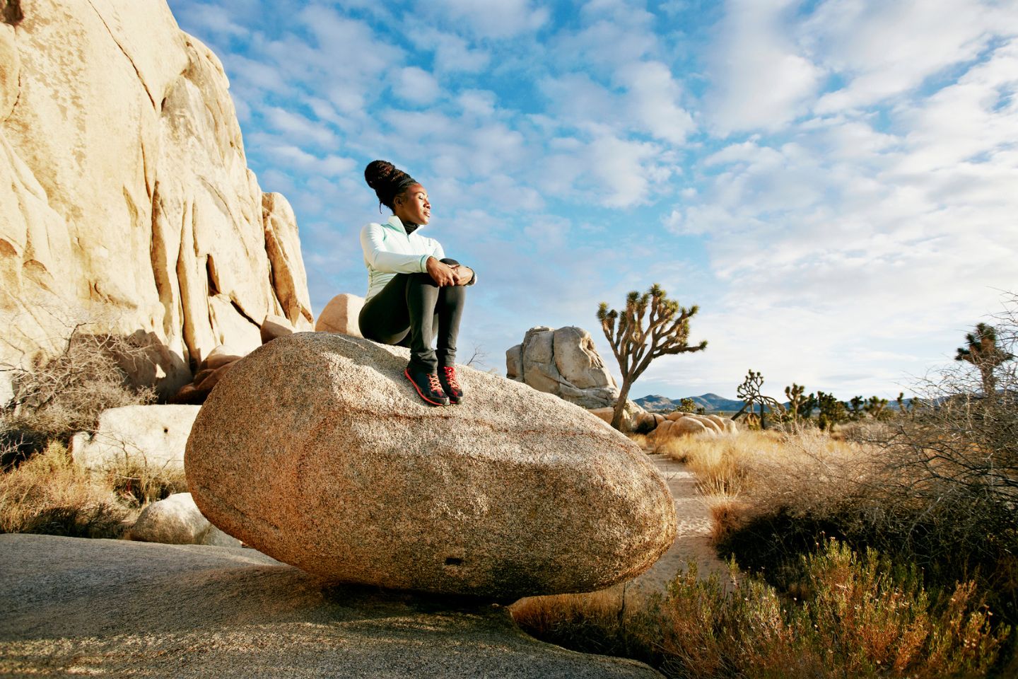 woman sitting on a rock in nature