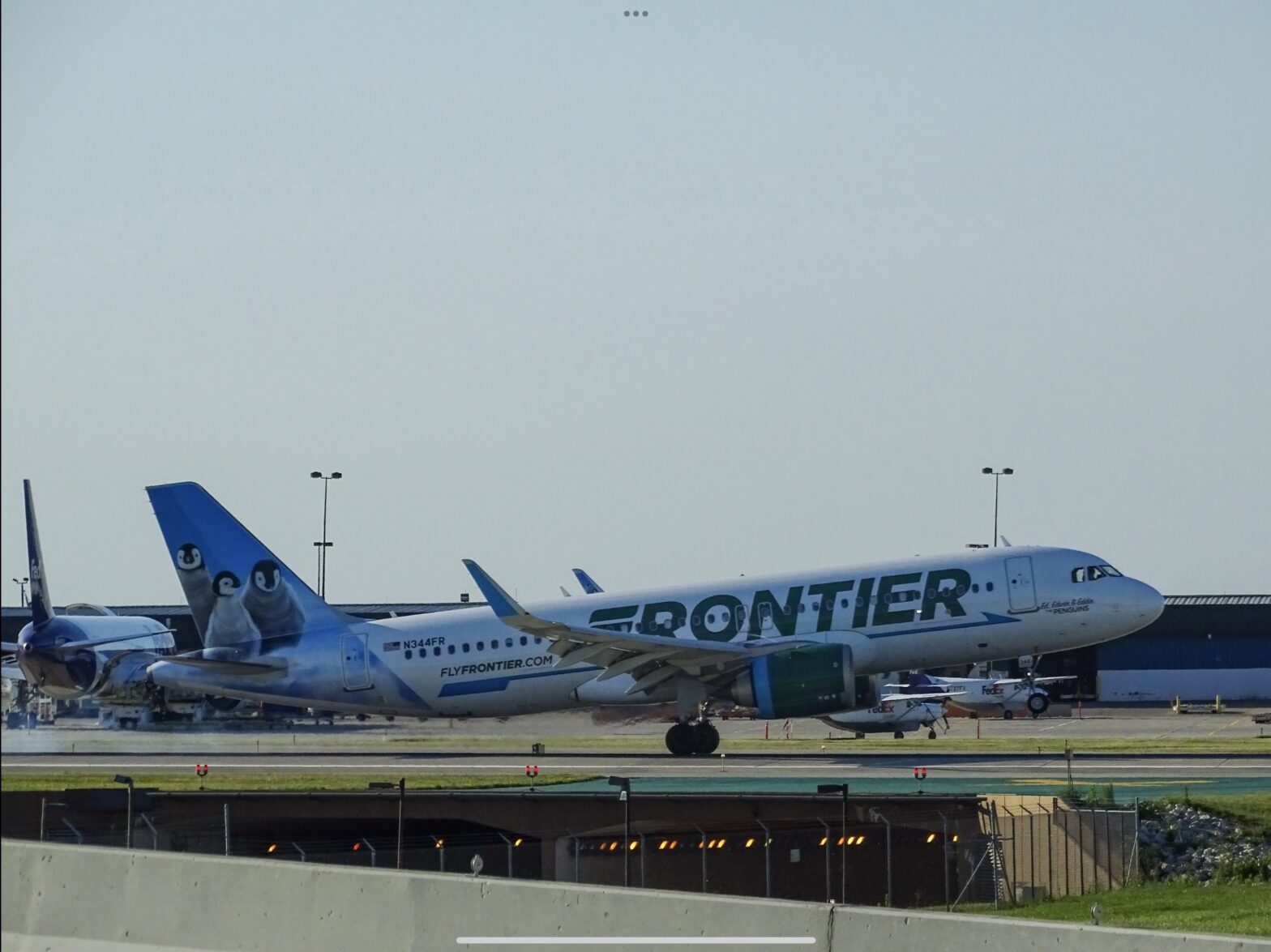 Frontier Airlines is a budget airline that many assume is unsafe due to its reputation. Learn more about if the airline is safe and is a good option for travelers. Pictured: A Frontier Flight with an image of penguins on its back wing on the tarmac ready for takeoff