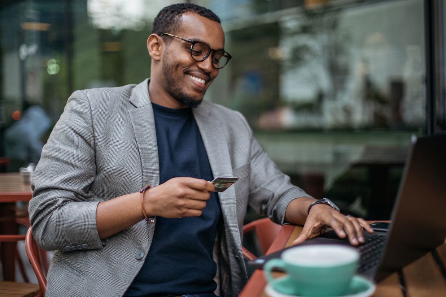 man at coffee shop online shopping