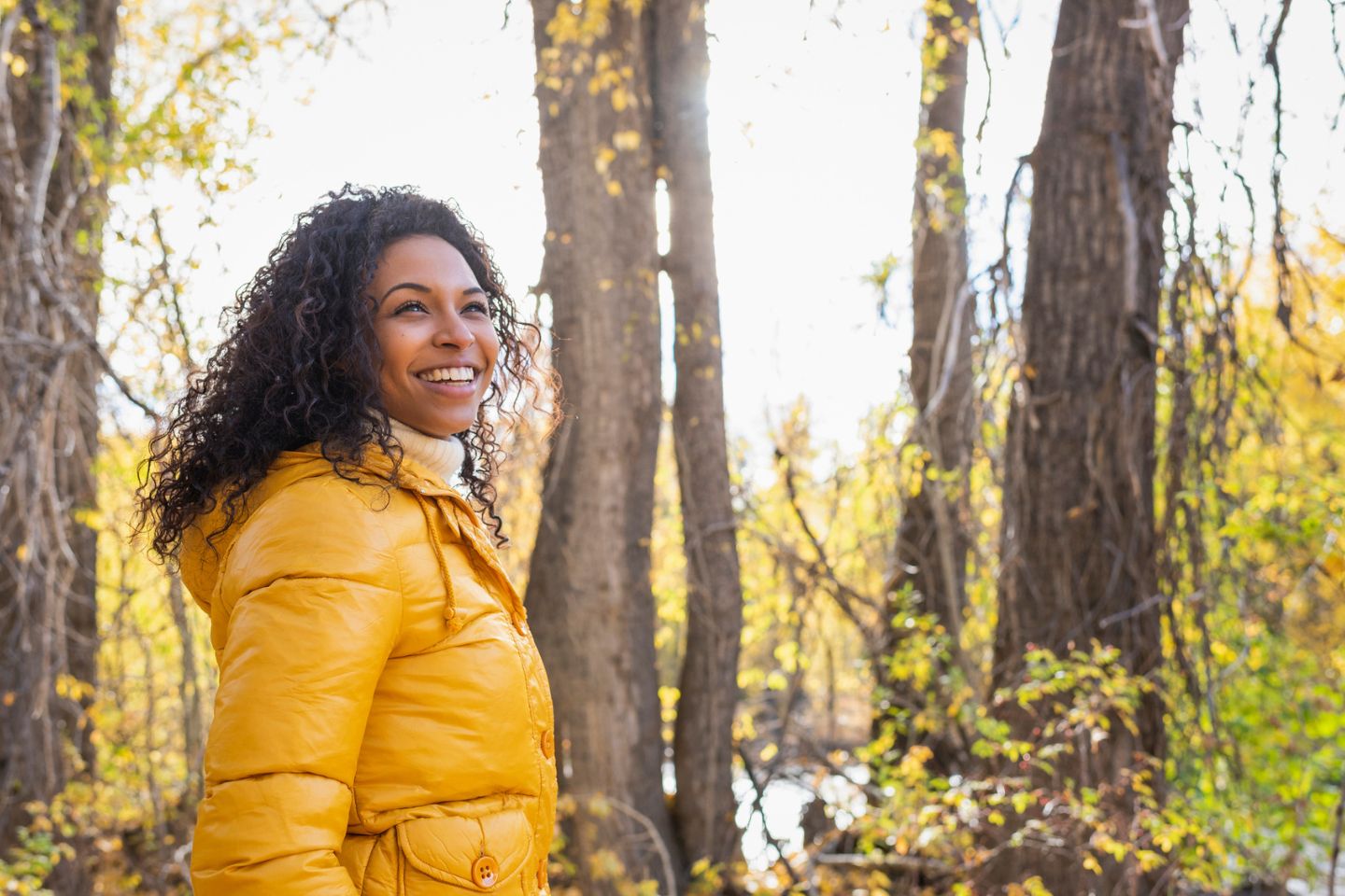 woman smiling in nature during the fall