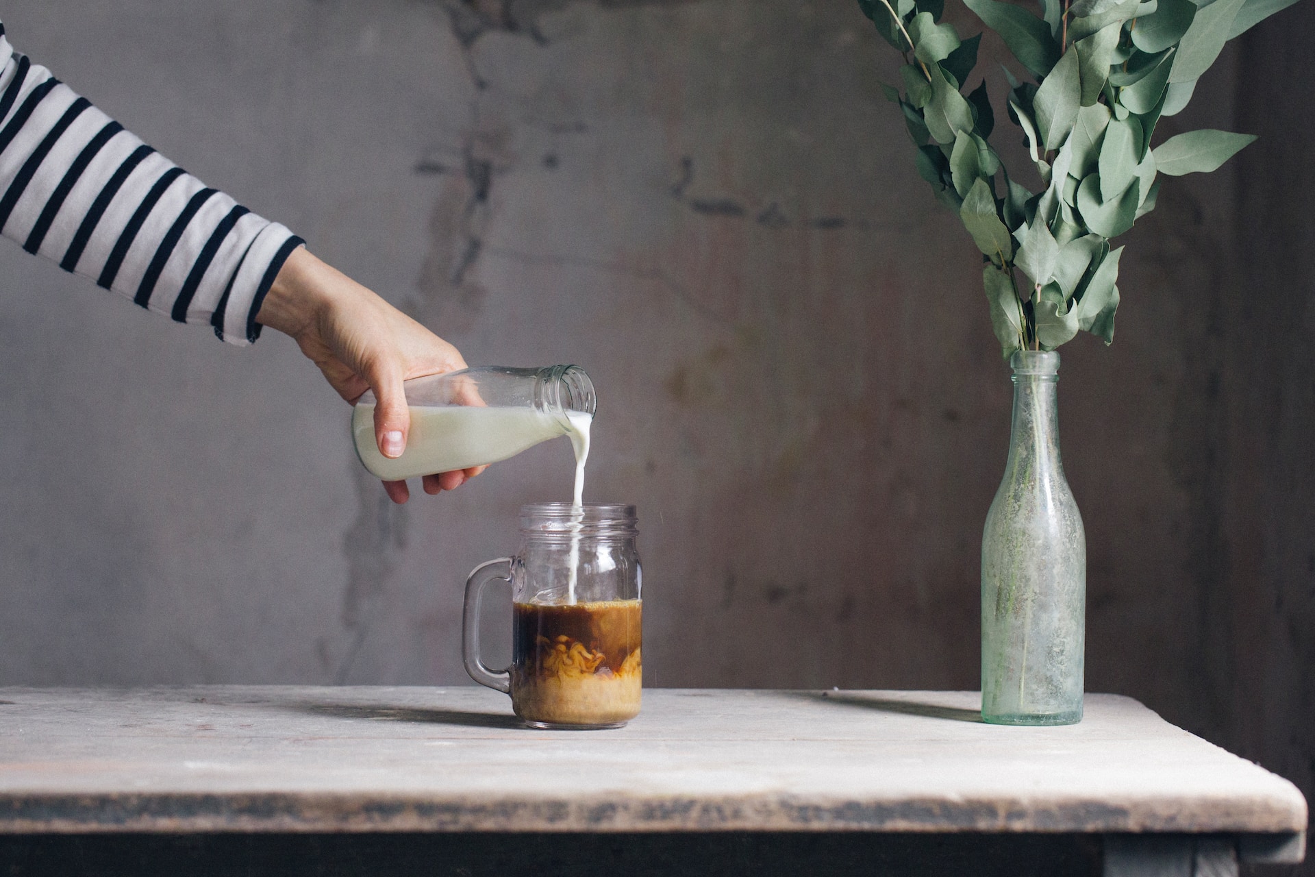 Pouring milk into coffee