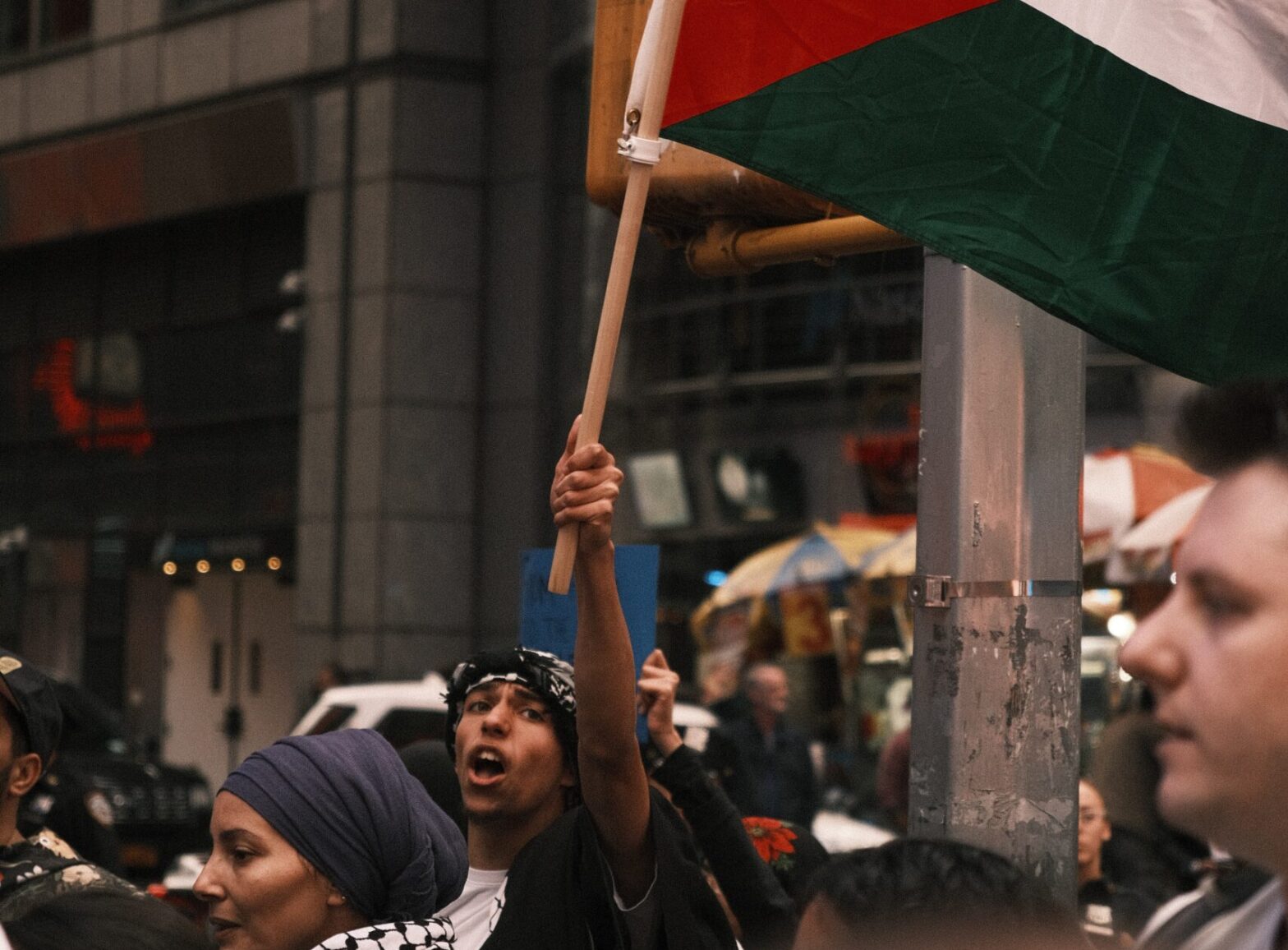 man holding Palestinian flag