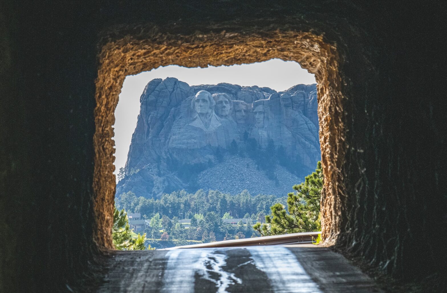 Here is your guide to the best things to do in Rapid City, SD. Pictured: the inside of a cave looking out to Mt. Rushmore.