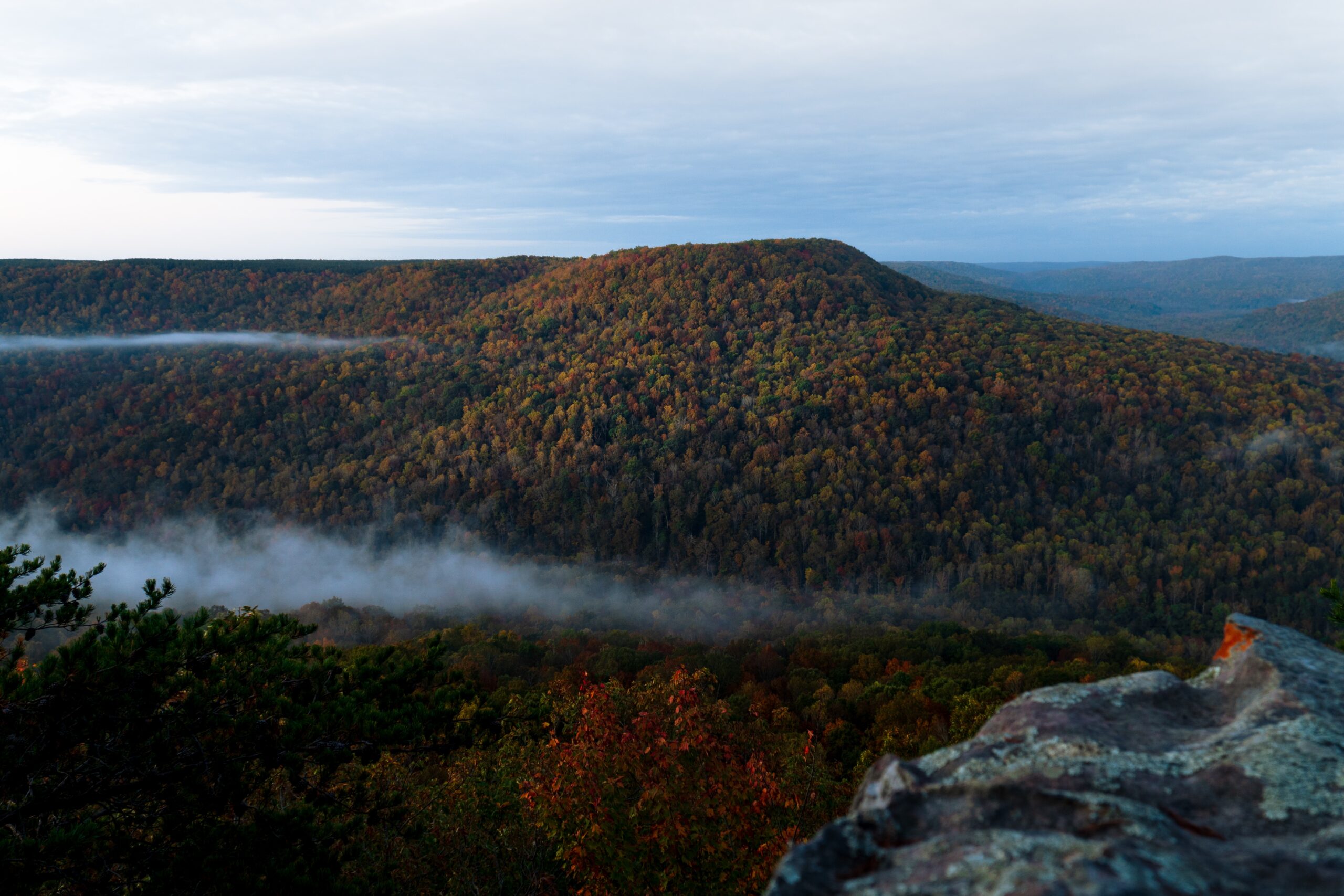 NSA Mid-South in Tennessee is a great destination that was used as a a filming location for the new Top Gun movie. 
pictured: The Tennessee mountains during fall on a cloudy day