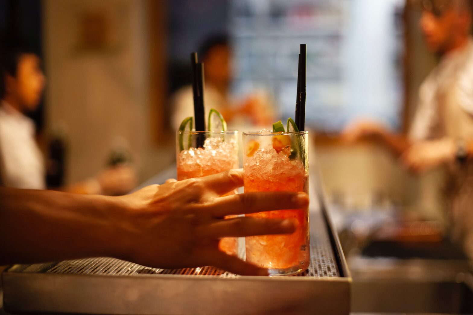 cocktails sitting on a bar