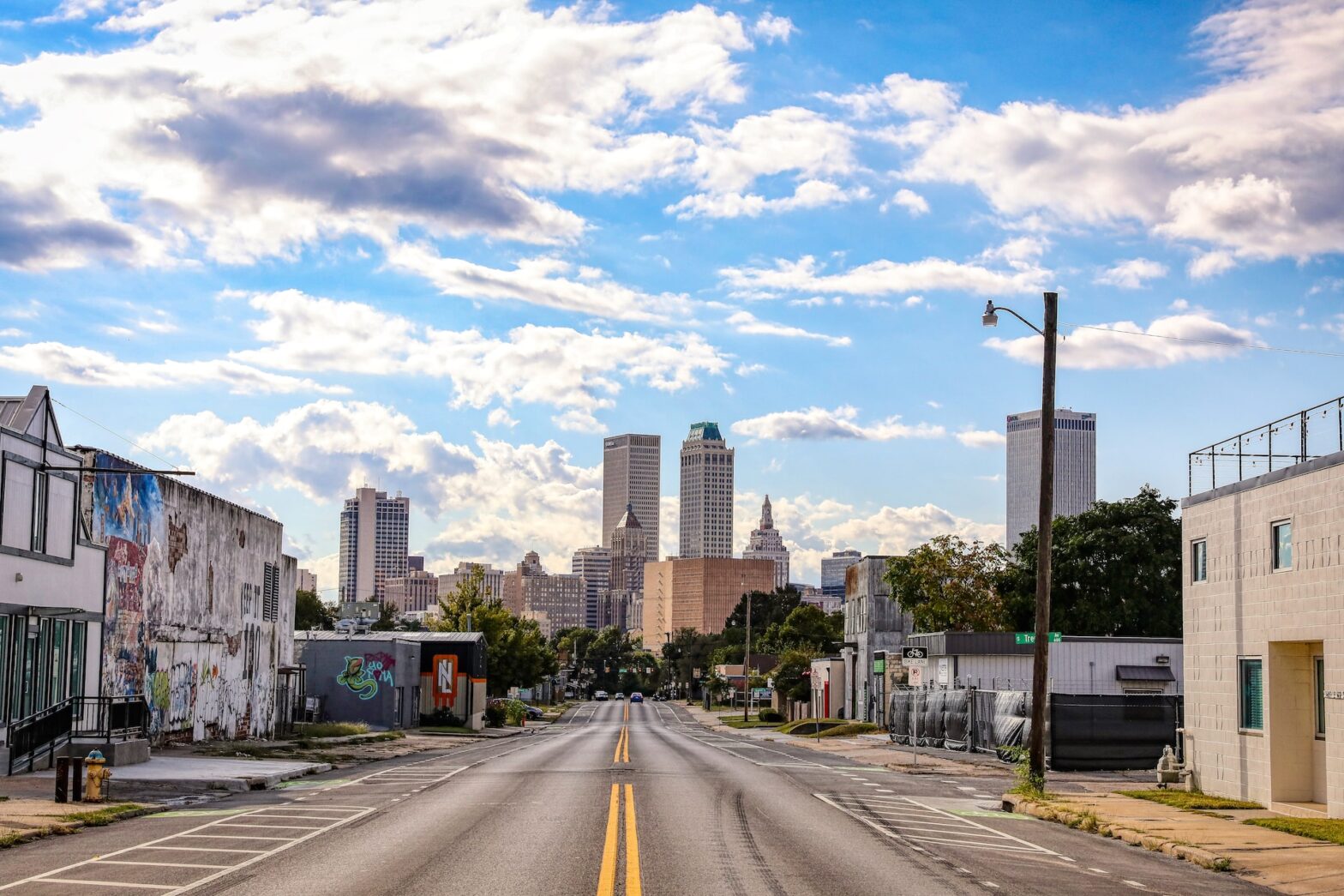 Her is A Guide of the Top 12 Things to Do in Tulsa that will make you interested in visiting. Pictured: a wide shot of a street in Tulsa, OK.