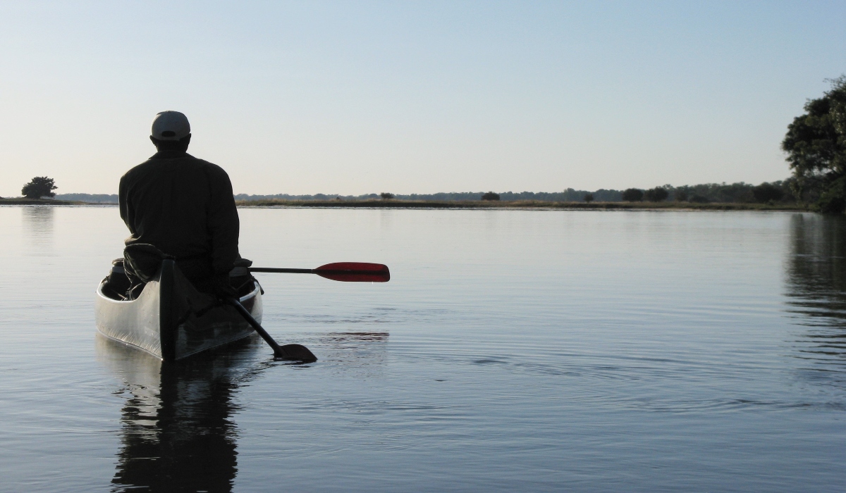 Man paddling a canoe on Zambezi River