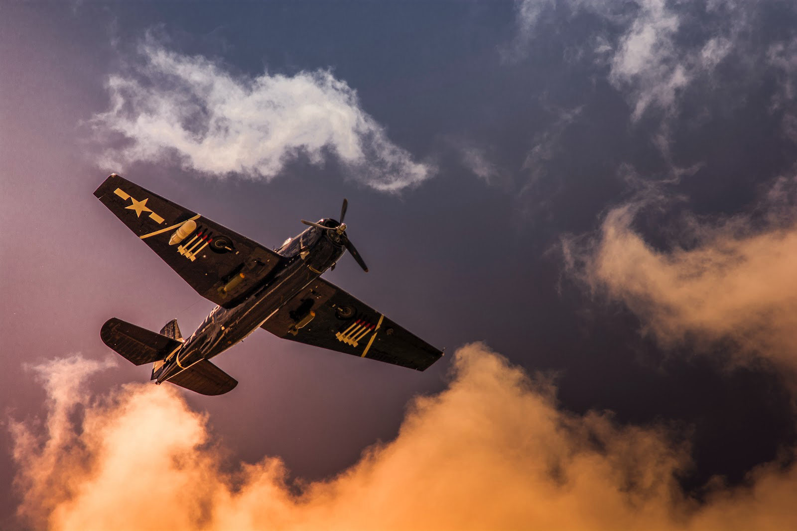 Learn more about why airplanes go to the boneyard and what happens to them there.
Pictured: an old plane flying in the cloudy sky