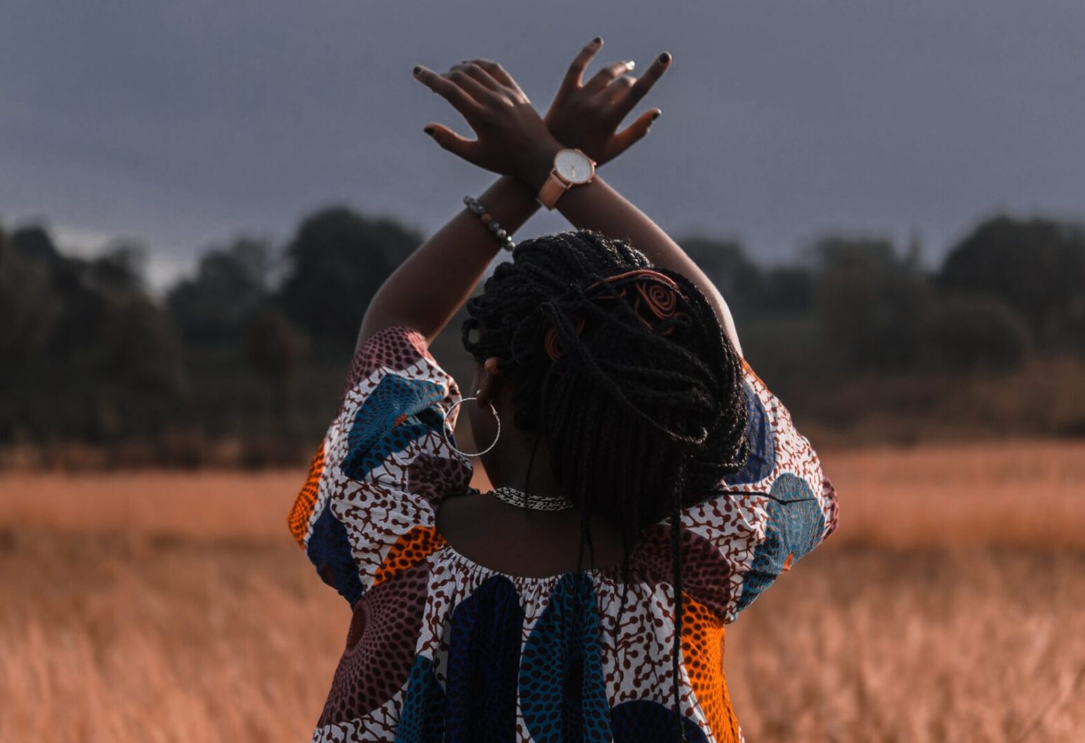 woman with arms raised in air