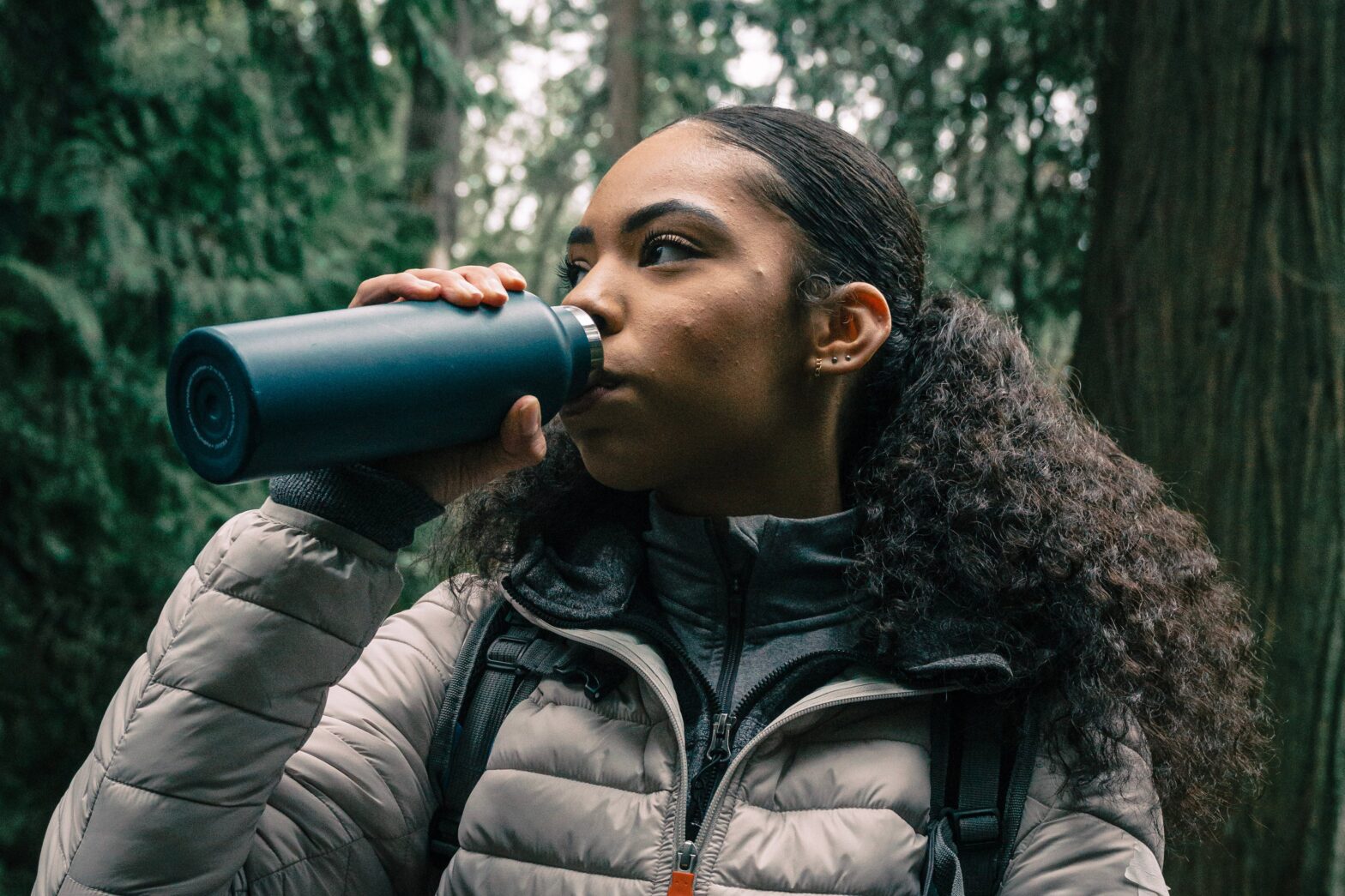 woman sipping water in the outdoors