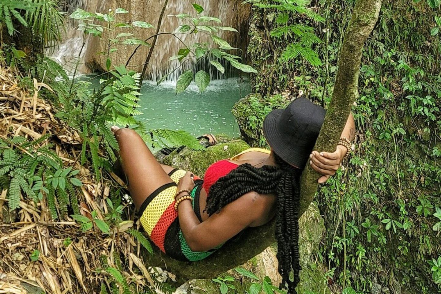 woman relaxing in the forest looking at waterfall in Jamaica