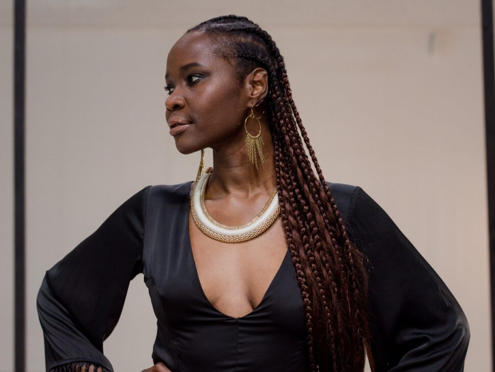 Woman in a Black Dress Posing with Her Hands on Her Waist