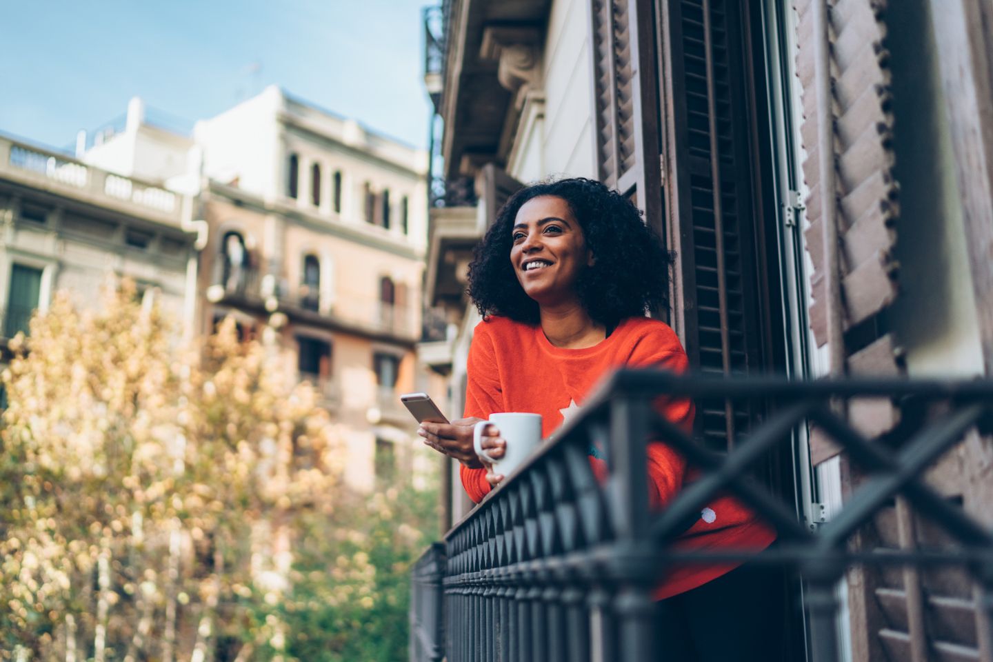 woman enjoying international vacation on balcony of flat