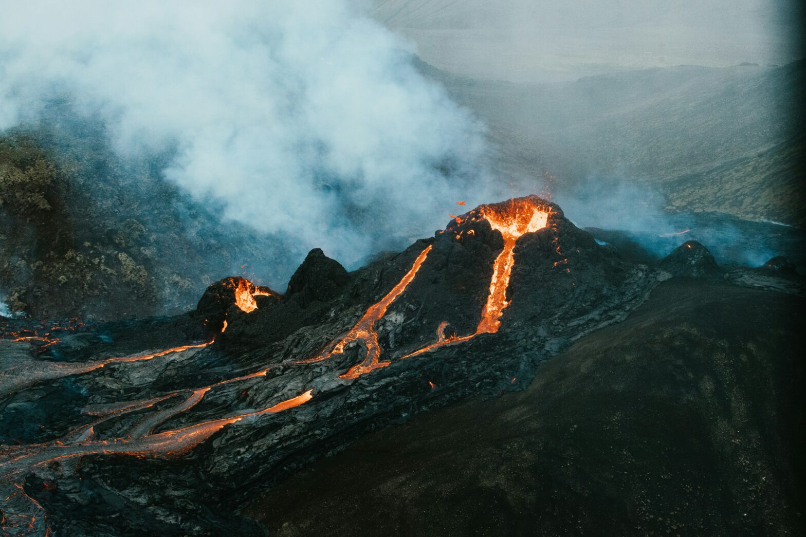 active volcano with smoke and lava