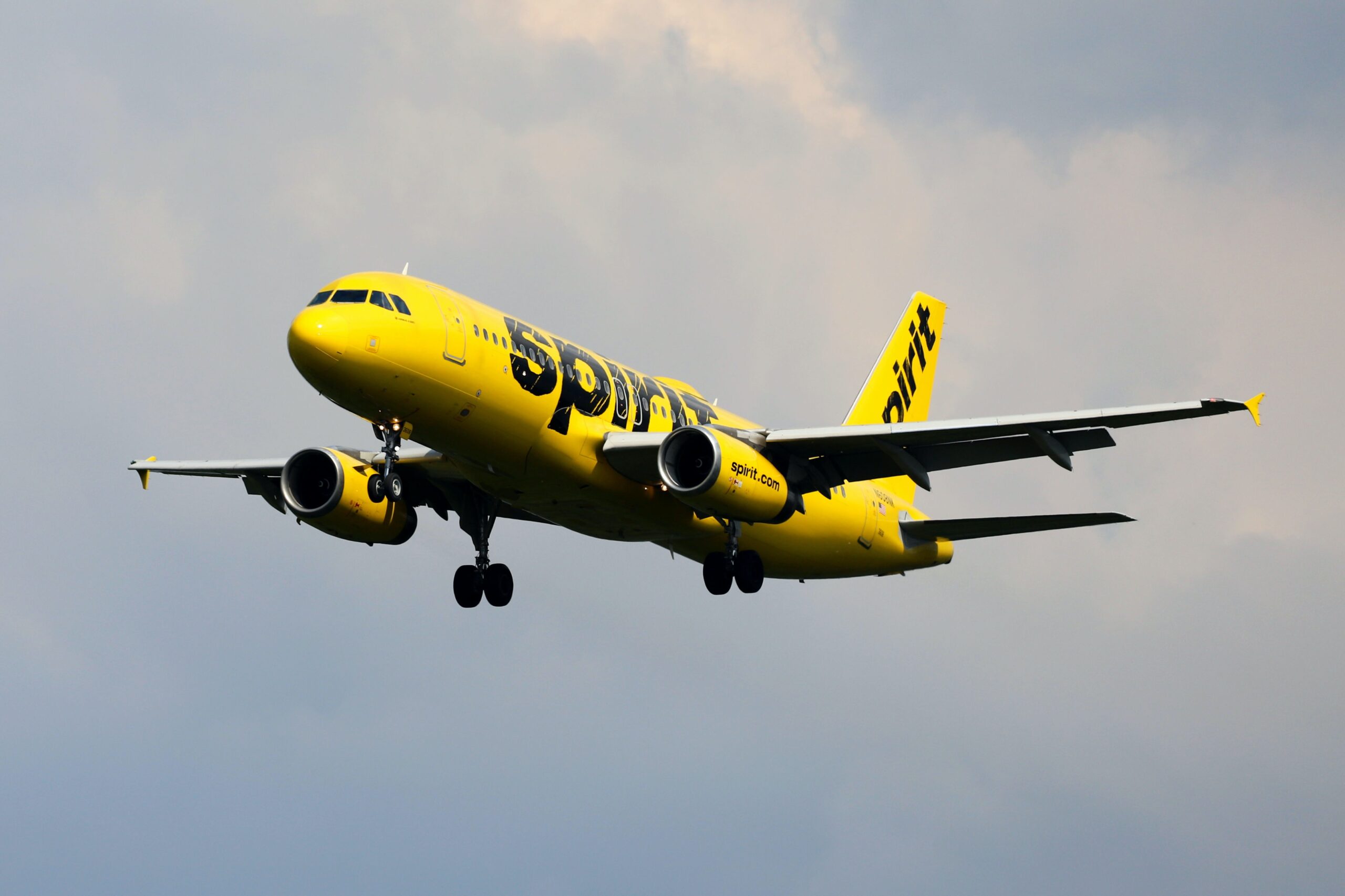 Spirit is an affordable airline that offers great budget prices for travelers.
pictured: a Spirit Airline airplane in the cloudy sky 