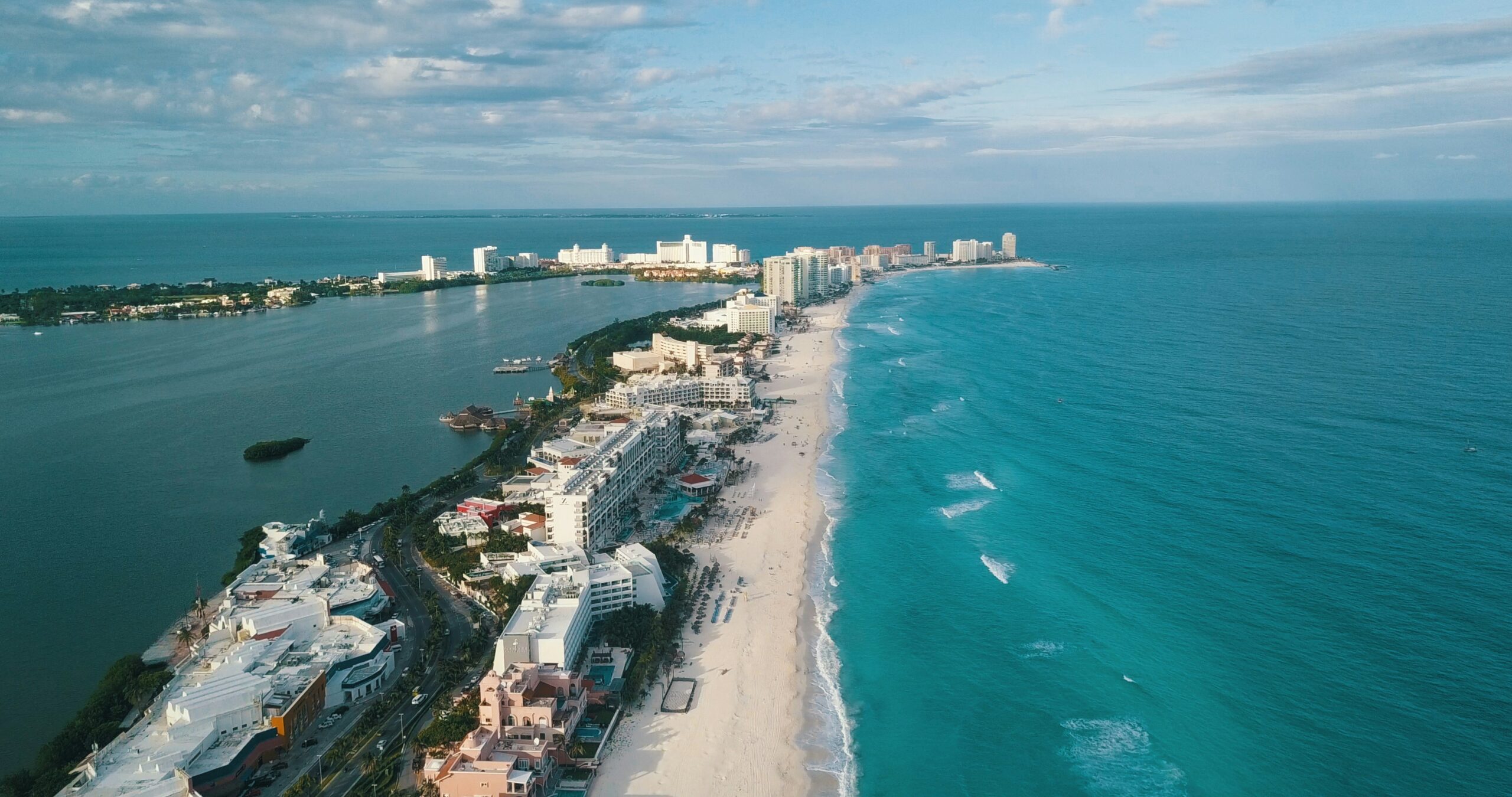 These food and shopping experiences in downtown Cancun are the top of the line for tourists. 
pictured: a seaside metropolitan strip of Cancun surrounded by turquoise waters