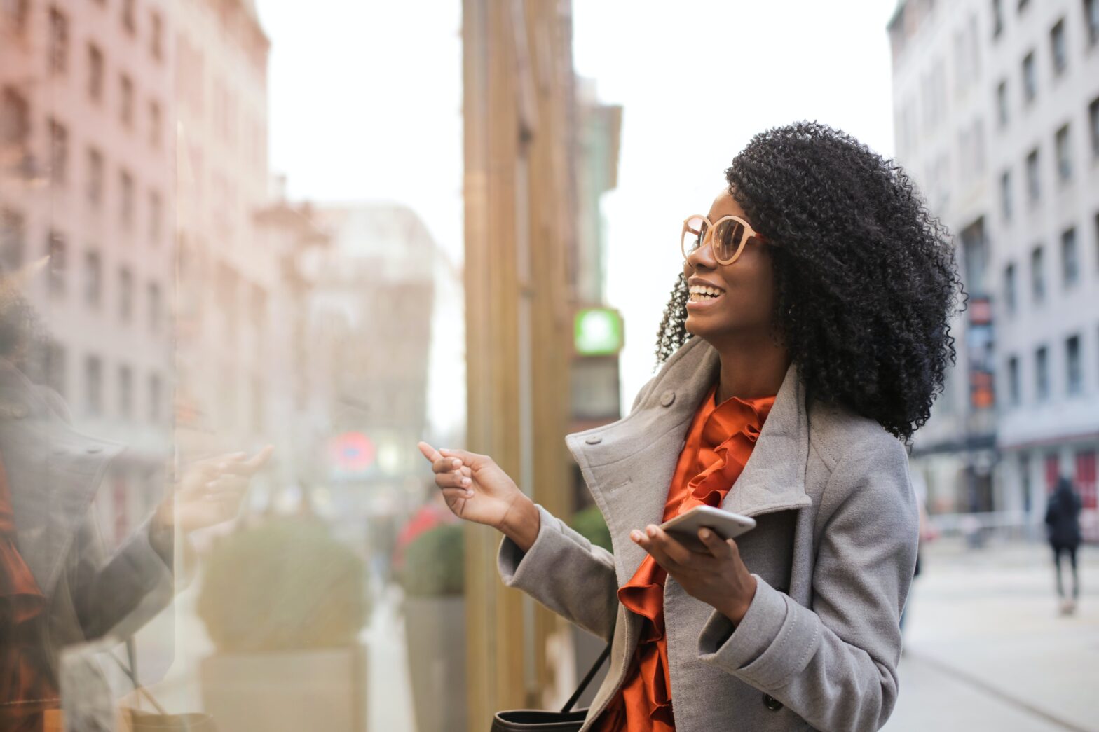 woman smiling while window shopping