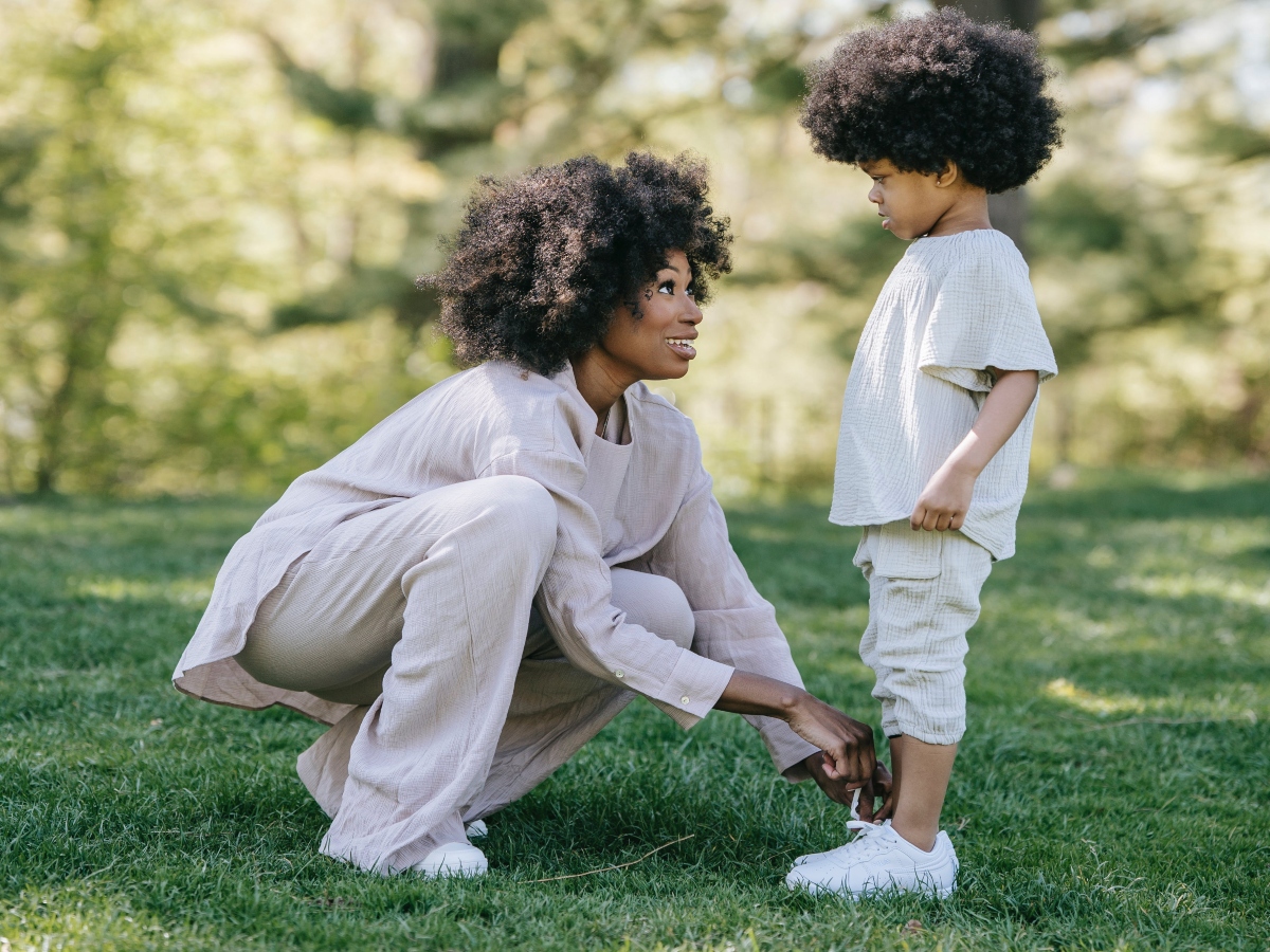 woman and child with natural hair playing in the park