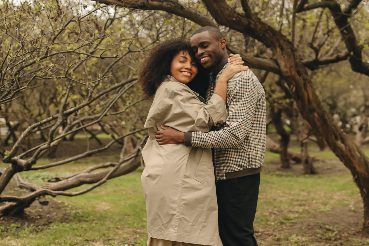 a Couple Hugging Near Trees