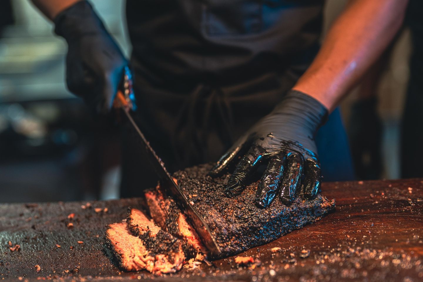 BBQ chef cutting brisket