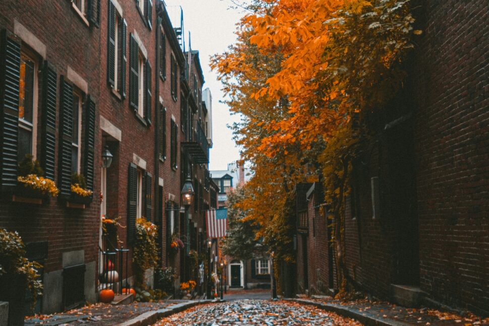 Fall leaves and pumpkin decor along an apartment alley in Boston, Massachusetts