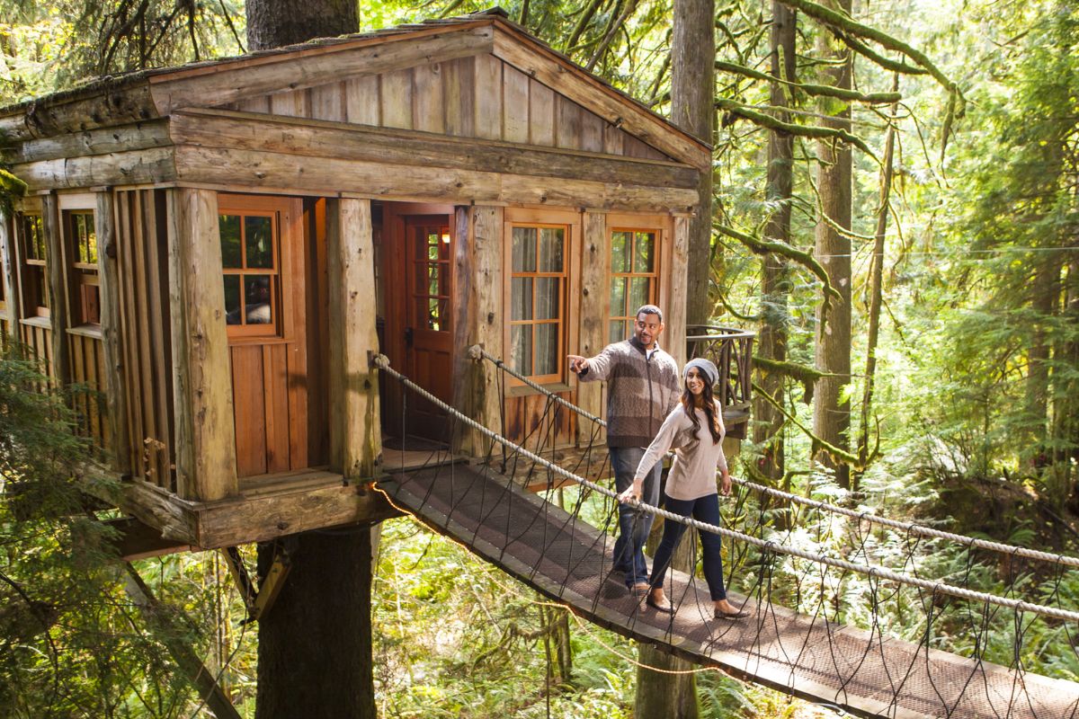 Couple on walkway of remote tree house