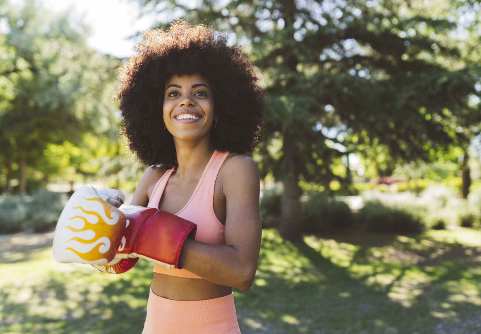 happy woman with boxing gloves outside