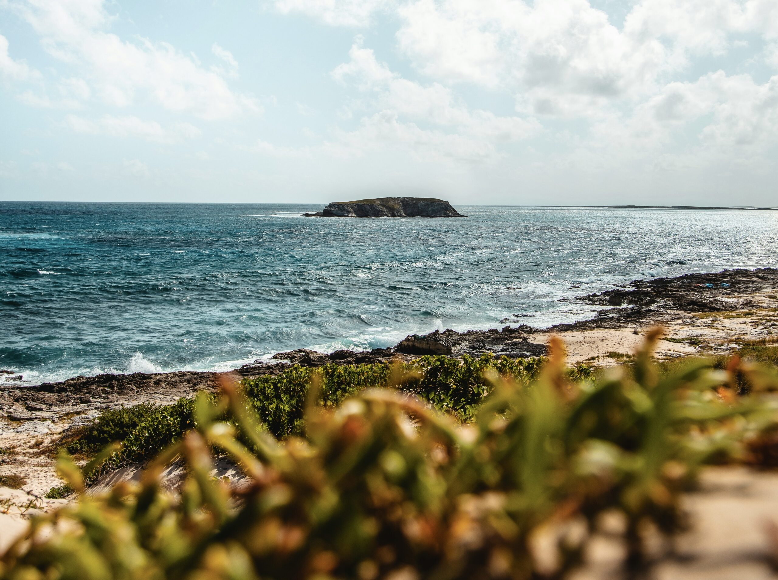 Here are ways to stay safe in the islands of Turks and Caicos. 
pictured: a distance and quaint island of the coast of Turks and Caicos 