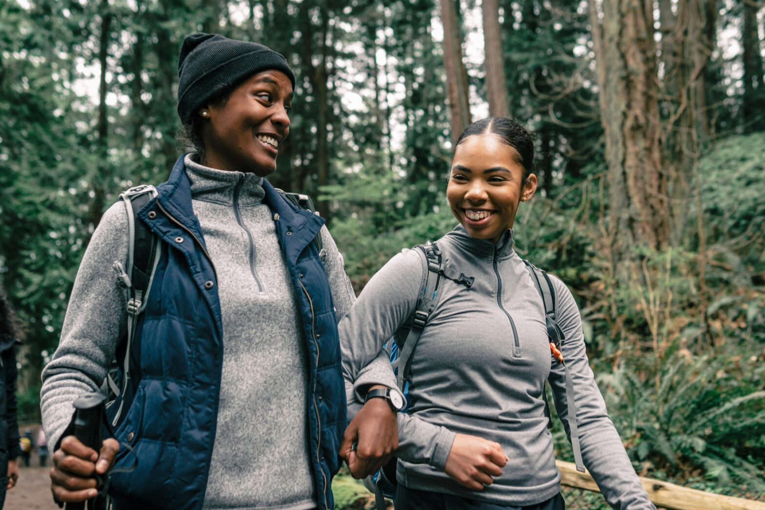 how to hike in extreme heat Pictured: travel friends walking and smiling