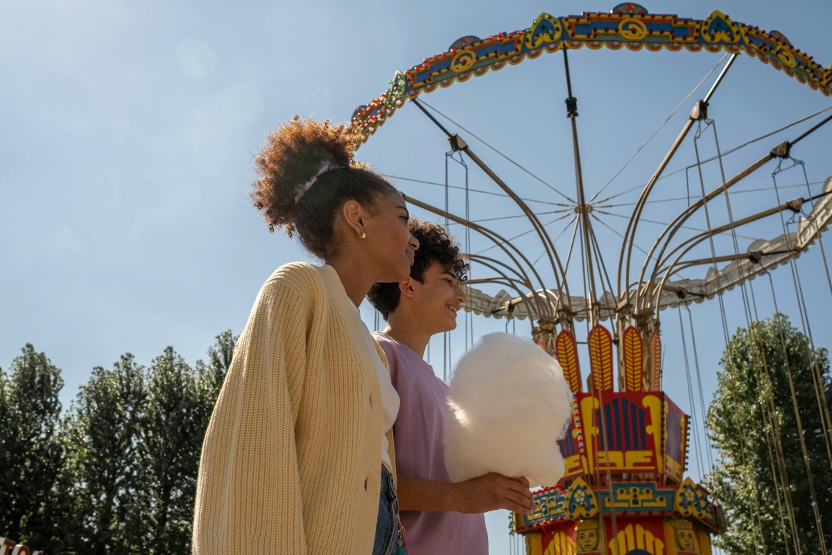 two women walking near a carnival ride