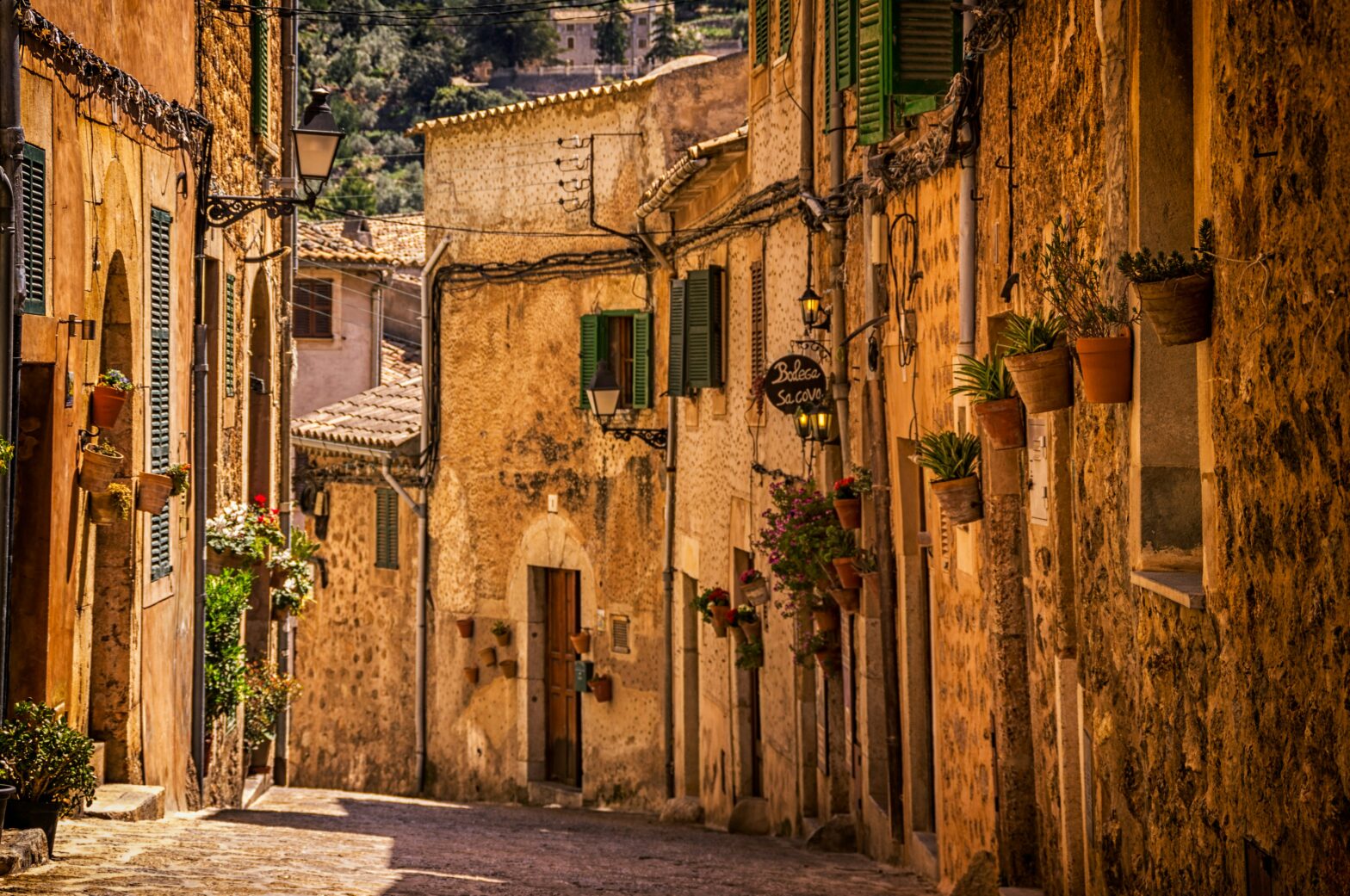 There are many cities in Spain that offer top notch experiences for travelers. These are the best cities to visit in Spain. Pictured: a charming street of Spain on a bright sunny day