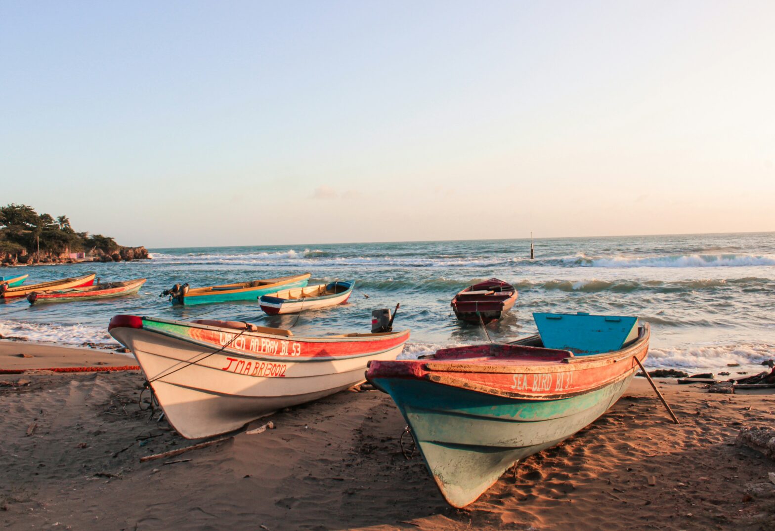 Jamaica is a country with plenty of tourism appeal but some travelers are unsure of its safety level. Learn more about whether or not Jamaica is safe. Pictured: a boat on the sand at a beach in Jamaica on a bright clear day