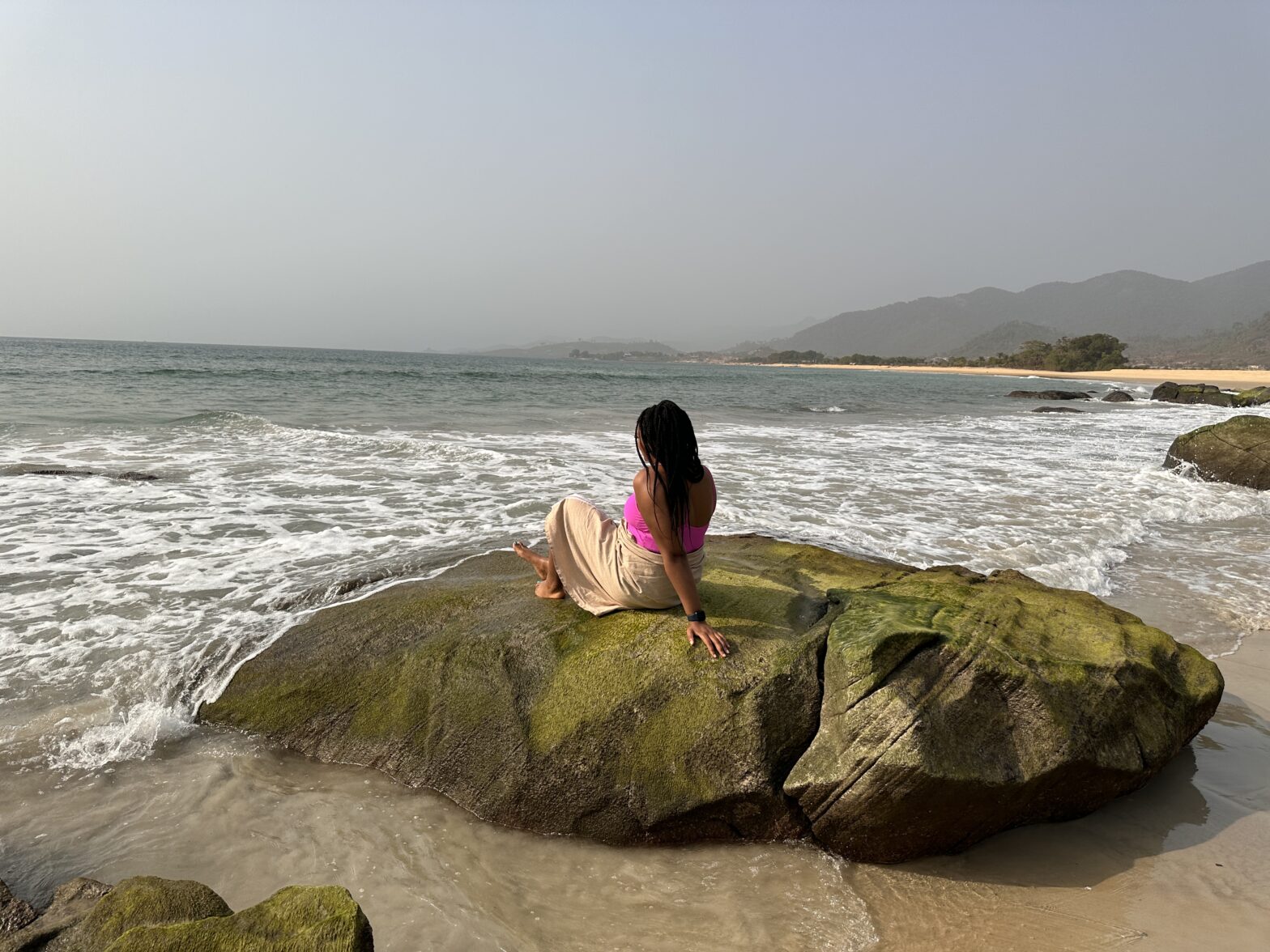 woman sitting on Bureh Beach in Sierra Leone