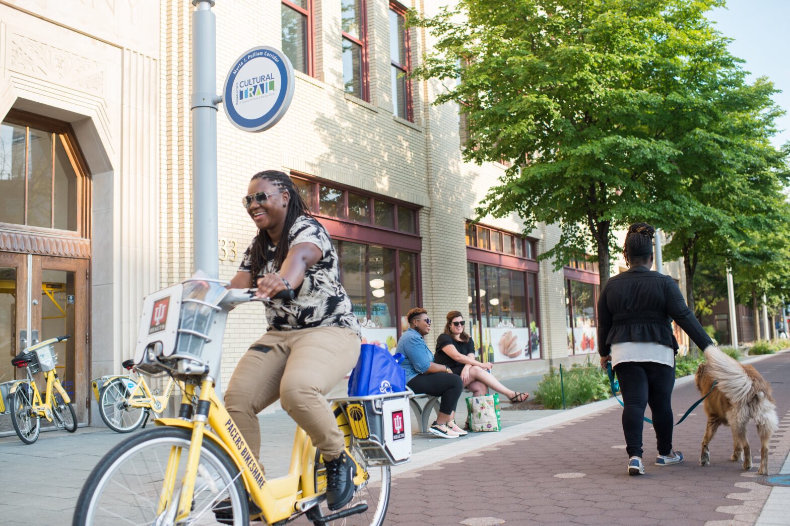 woman smiling on bike on the Indianapolis Culture Trail