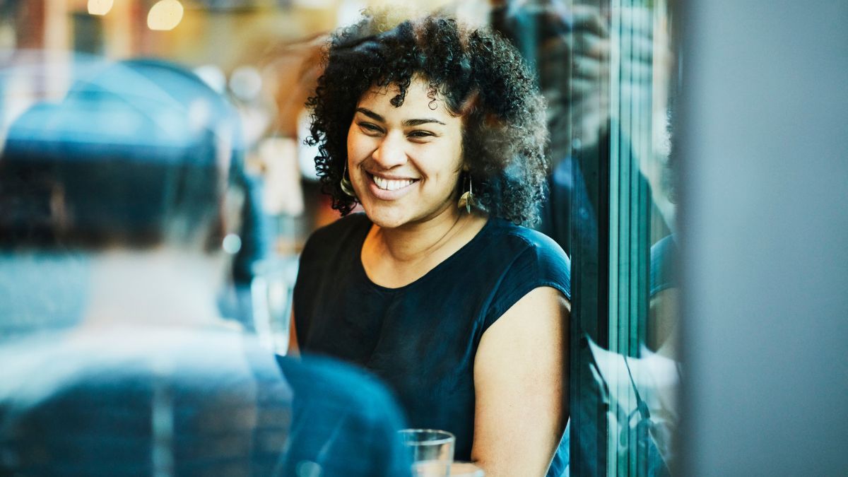 woman sitting a restaurant talking to someone