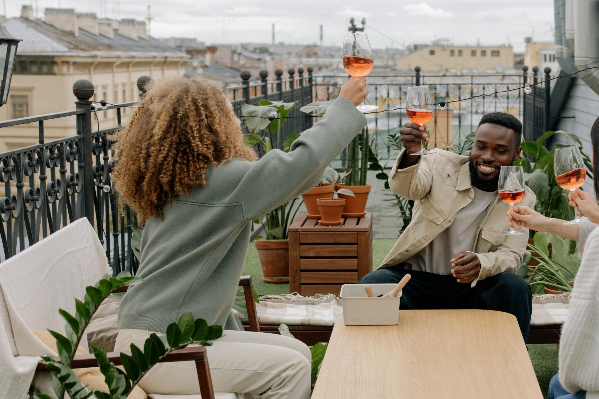 friends toasting over drinks on an outdoor patio