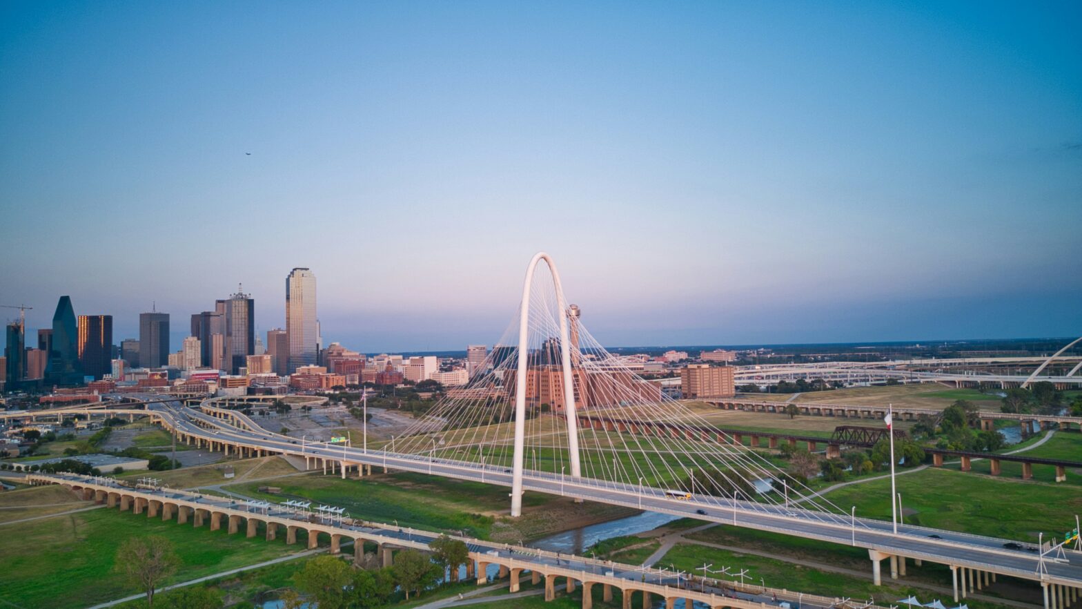 Learn about these road trip destinations from Dallas that will excite travelers. pictured: a view of Dallas, Texas' bridge and overlook near sunset