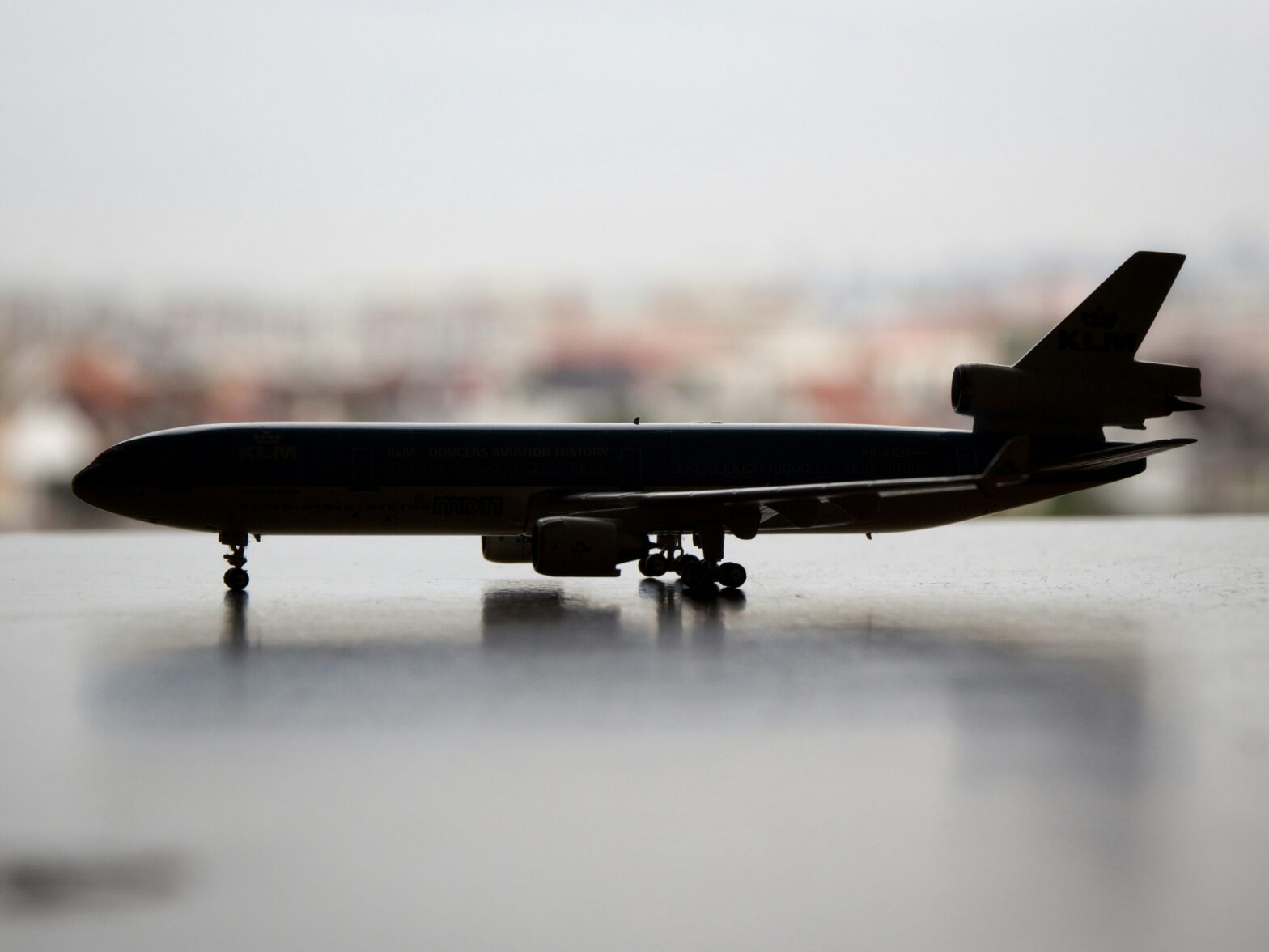 Learn about whether or not Boeing is the only airplane manufacturer. Pictured: a toy plane situated on a marbled surface in front of a cityscape