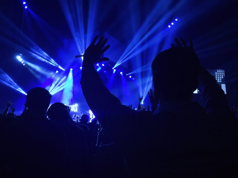 lights at a music festival shinning over the crowd