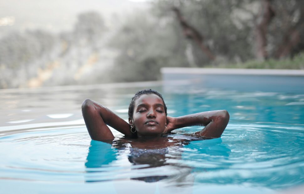 woman emerging from water while swimming