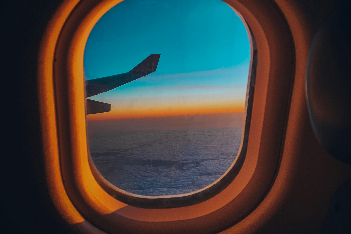 view of clouds from inside airplane window