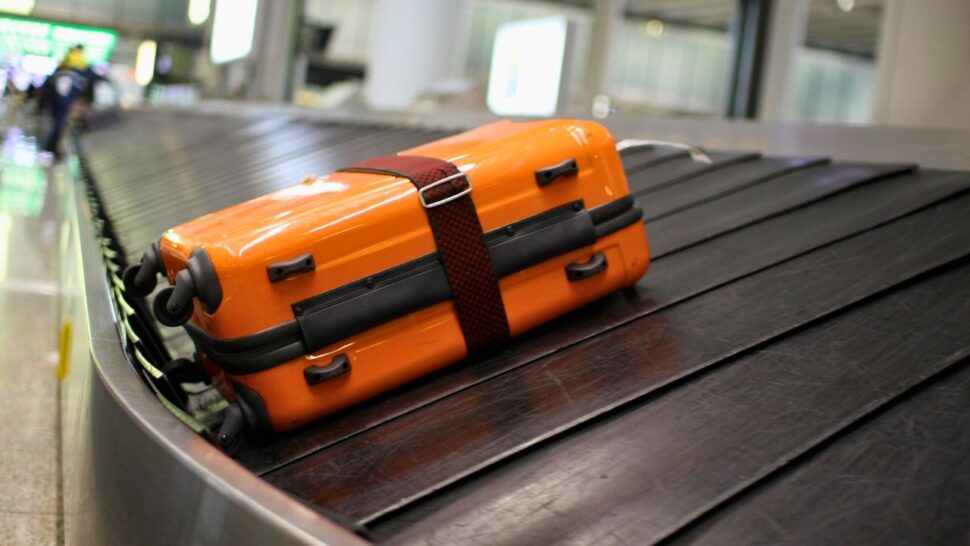 lone suitcase on conveyor belt at baggage claim