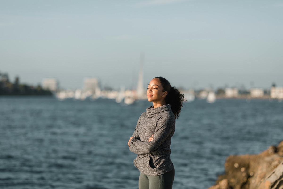 Woman Relaxing While Standing Near Body of Water