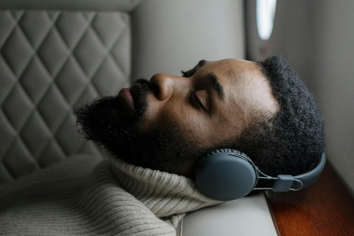 a man listening to music while flying