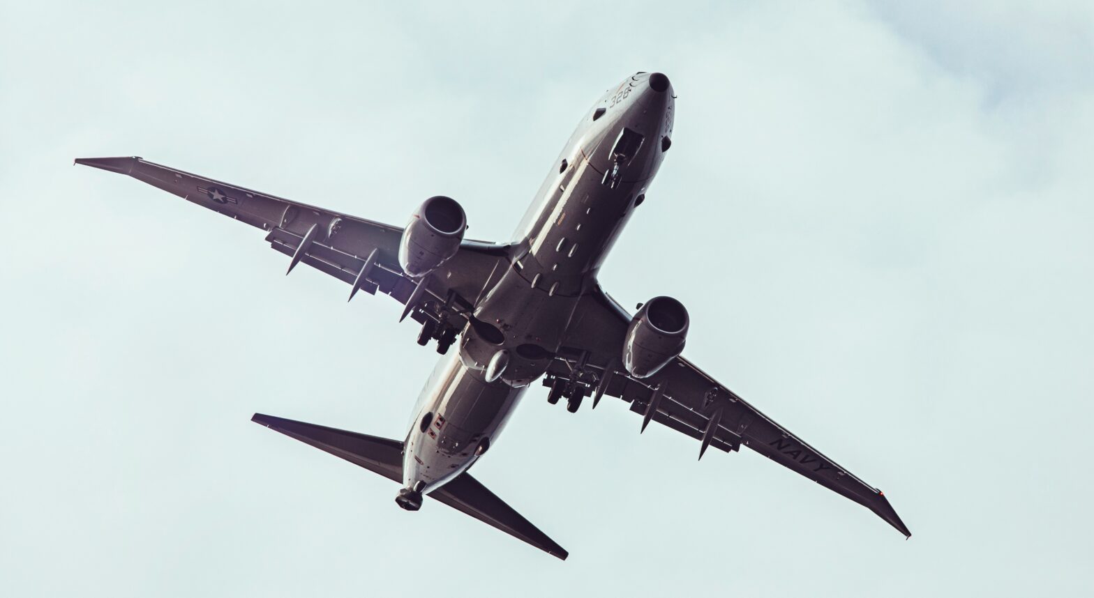 Learn what is happening with United Airline’s pilots and Boeing aircraft. Pictured: the underside of a Boeing 737 on a cloudy day