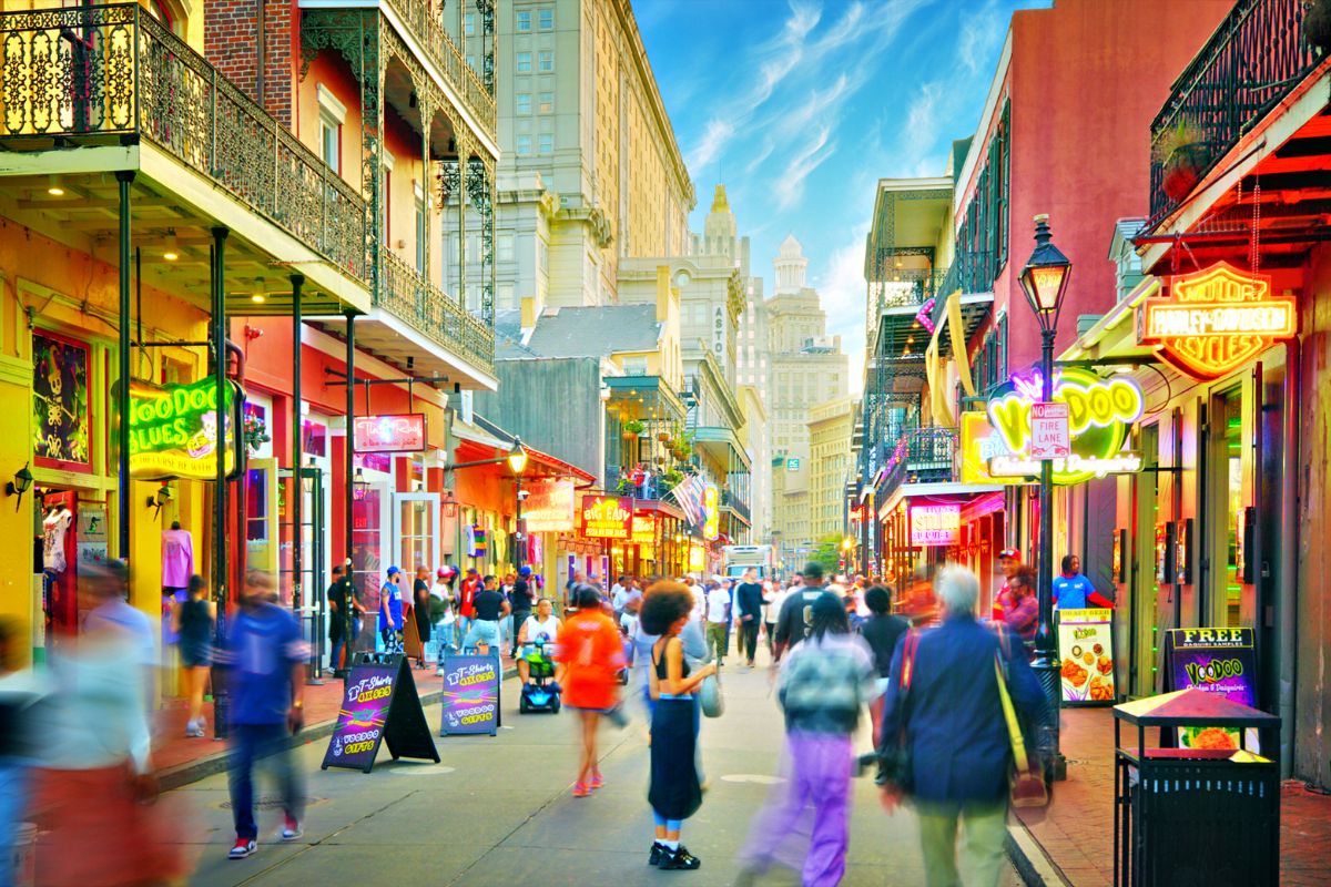 people walking along Bourbon Street during the day in New Orleans