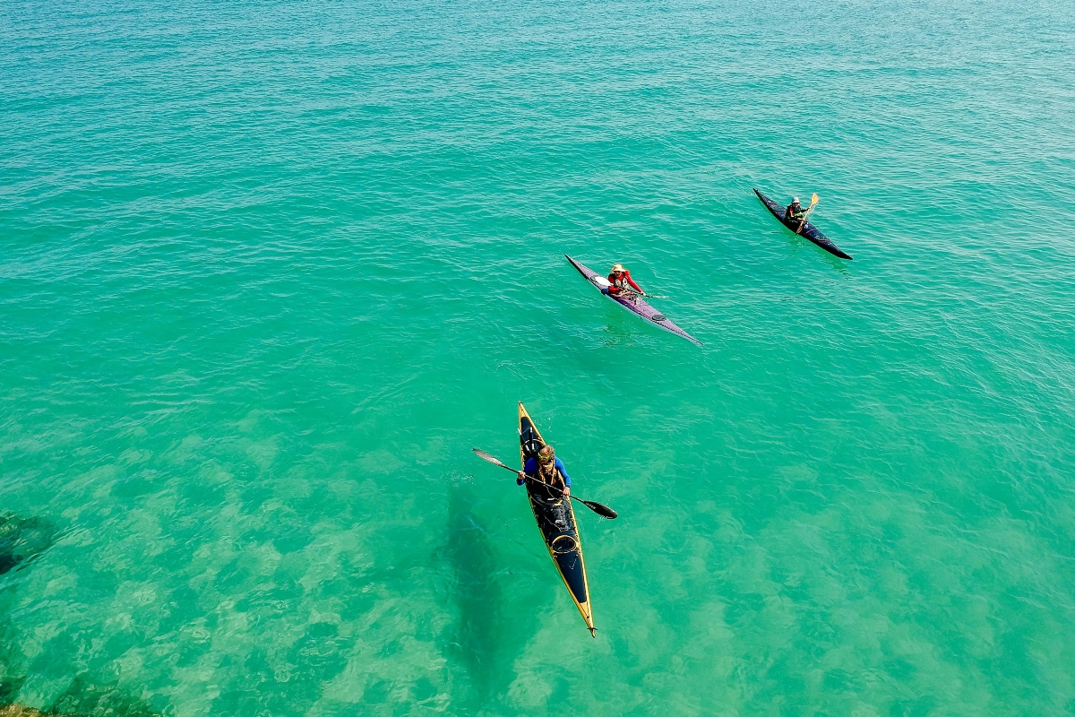 people kayaking in the ocean