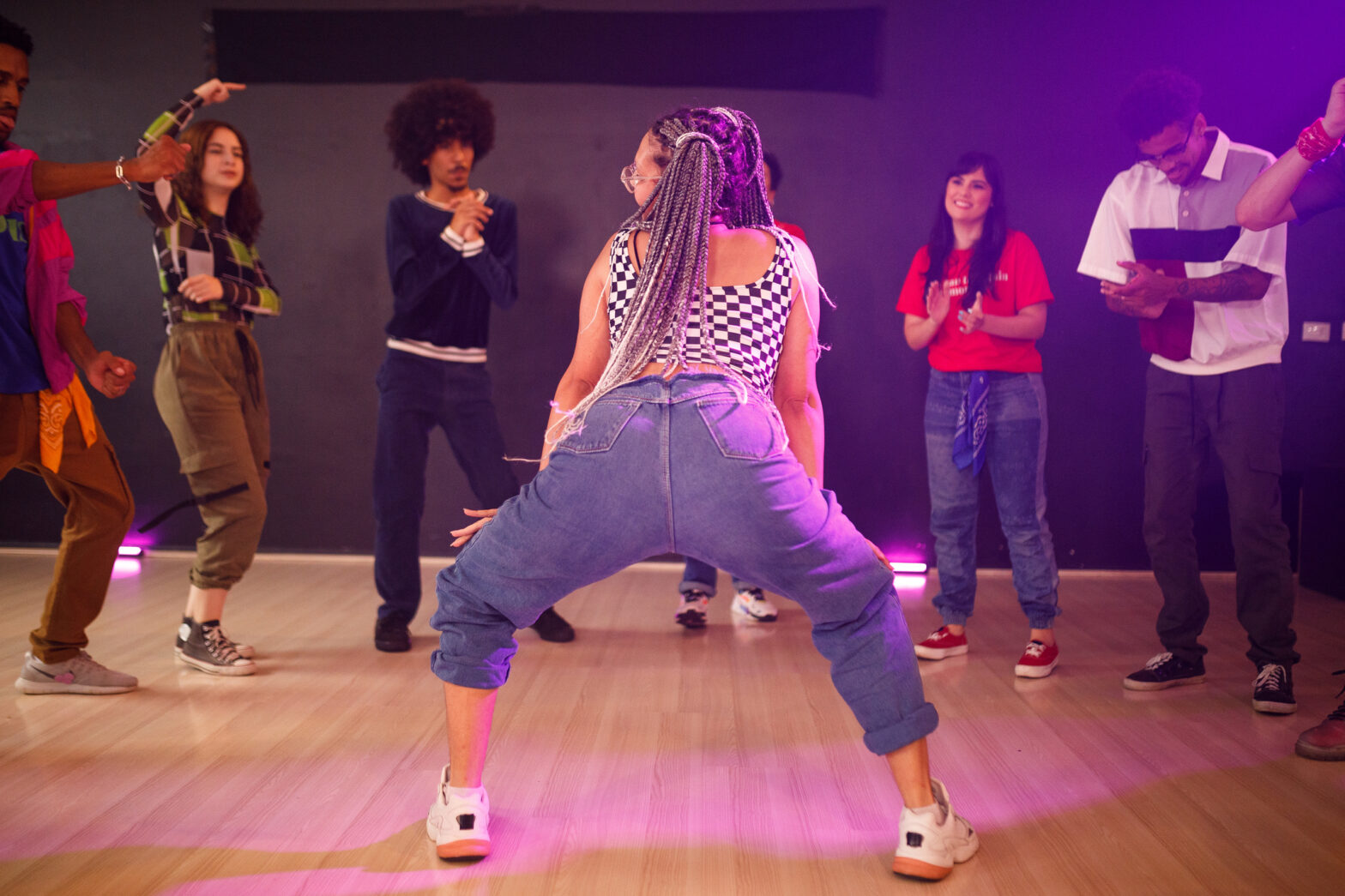 Woman with braided hair twerking at a party