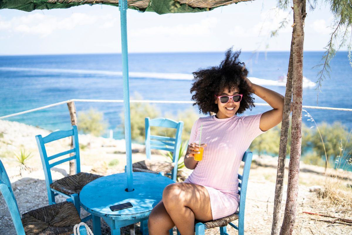 woman enjoying a drink on a summer vacation