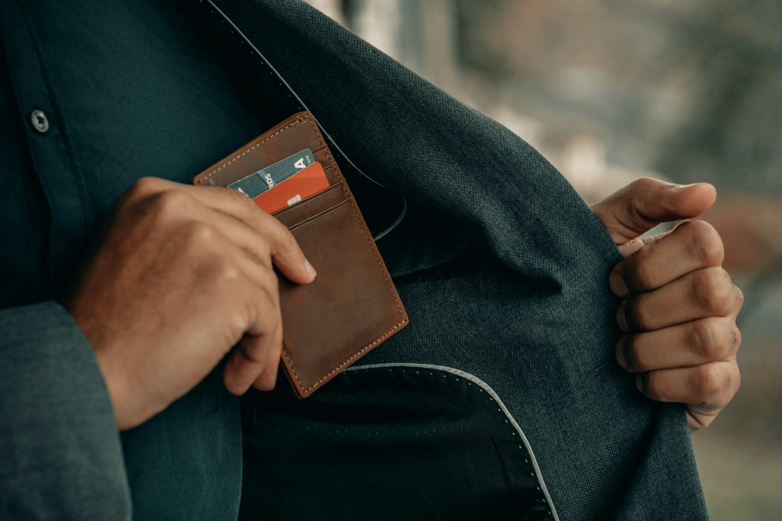 These are the ratings on European pickpocketing of tourists. pictured: a Black man putting his wallet back in his jacket